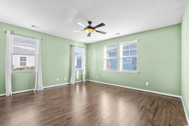 unfurnished room with dark hardwood / wood-style floors and ceiling fan