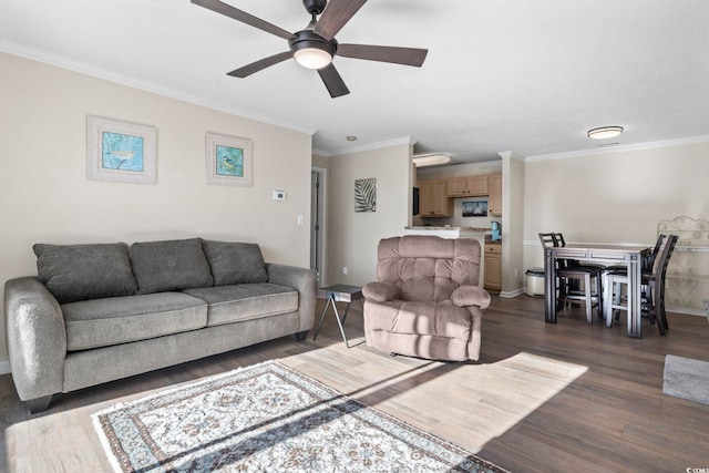 living room with dark hardwood / wood-style floors, ceiling fan, and ornamental molding