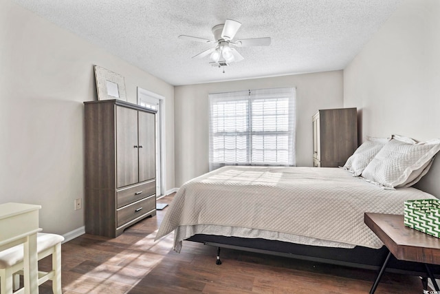 bedroom featuring a textured ceiling, ceiling fan, and dark wood-type flooring