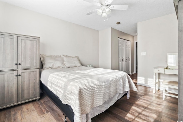 bedroom featuring dark hardwood / wood-style flooring, a closet, and ceiling fan