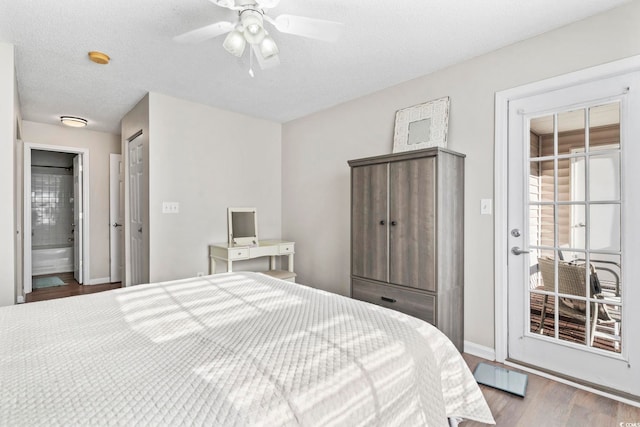 bedroom with hardwood / wood-style floors, ceiling fan, and a textured ceiling