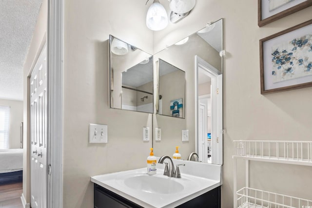 bathroom featuring vanity and a textured ceiling