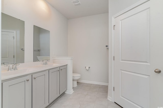 bathroom with tile patterned floors, vanity, and toilet