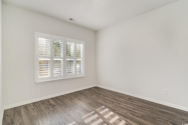 empty room with dark hardwood / wood-style flooring