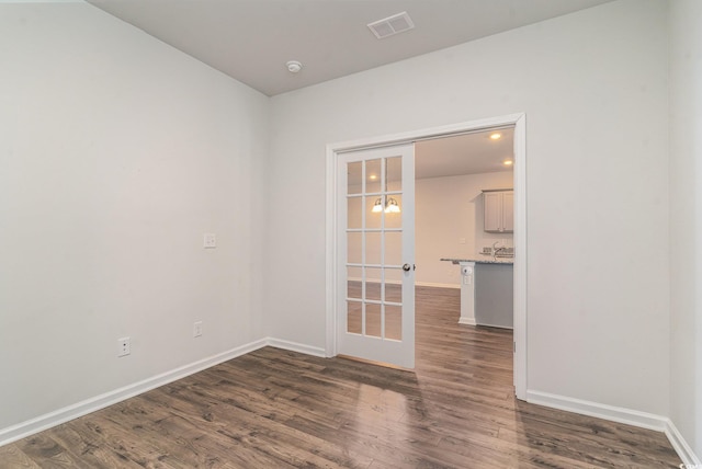 spare room with dark wood-type flooring