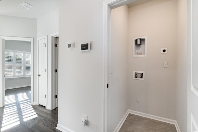 laundry room with electric dryer hookup, hookup for a washing machine, and dark wood-type flooring