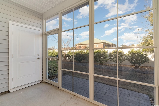 doorway to outside featuring wooden walls