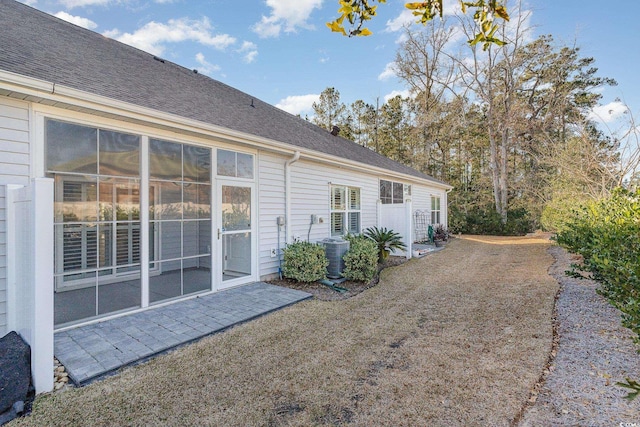 rear view of house with a sunroom and cooling unit