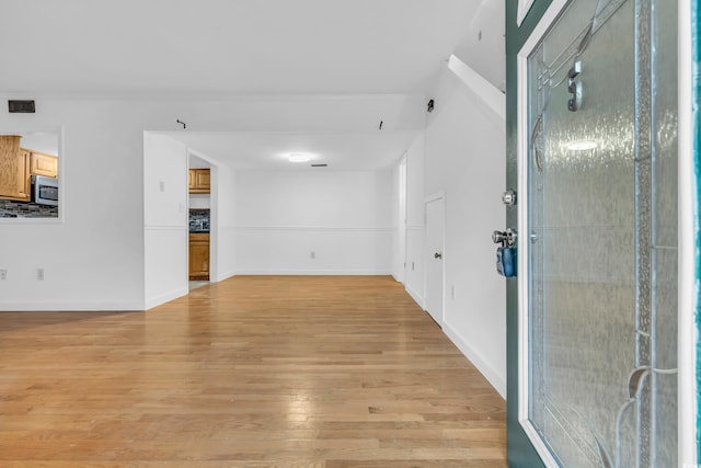 unfurnished living room featuring light wood-type flooring