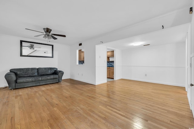 living room featuring ceiling fan and light hardwood / wood-style floors