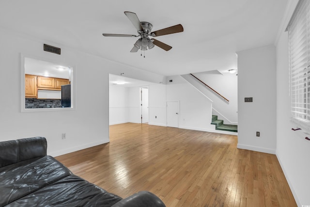 living room with ceiling fan and light hardwood / wood-style floors