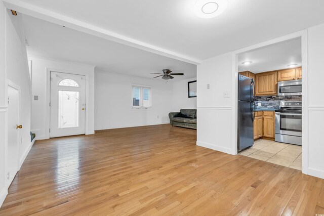 unfurnished living room with ceiling fan and light hardwood / wood-style floors