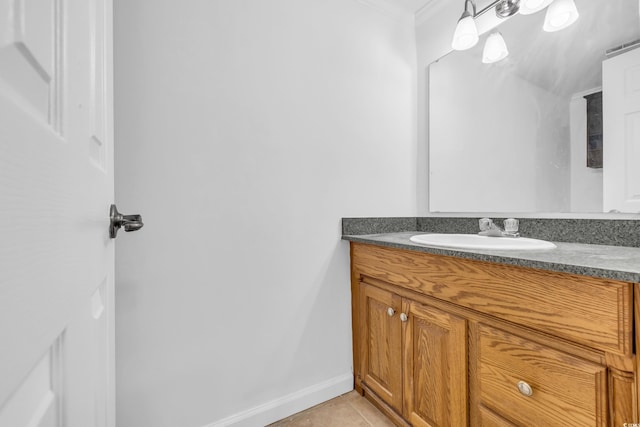 bathroom with tile patterned floors, vanity, and crown molding