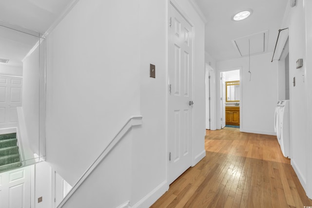 hall featuring light wood-type flooring and ornamental molding