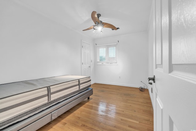 bedroom with ceiling fan, ornamental molding, and light hardwood / wood-style flooring