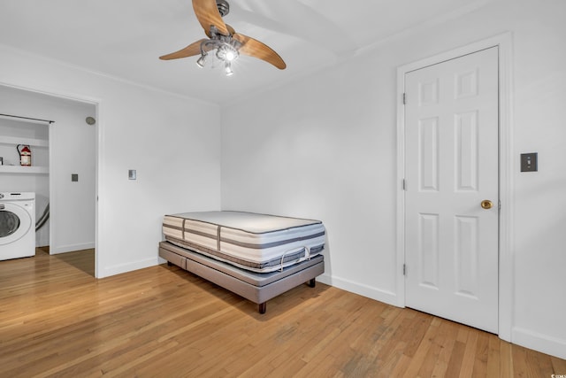 bedroom with washer / dryer, ceiling fan, and light hardwood / wood-style floors