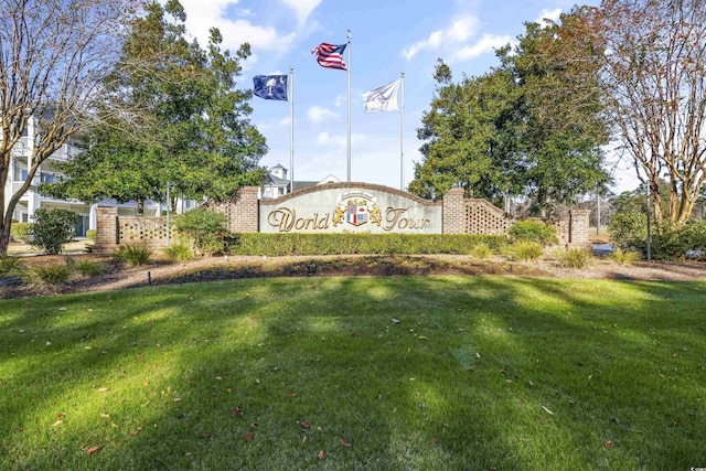 community sign featuring a lawn