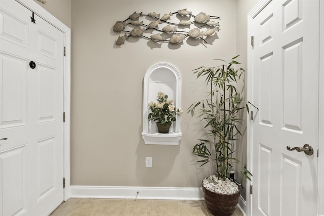 corridor with light tile patterned flooring