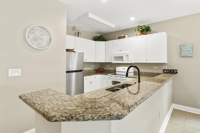 kitchen featuring kitchen peninsula, white appliances, and sink