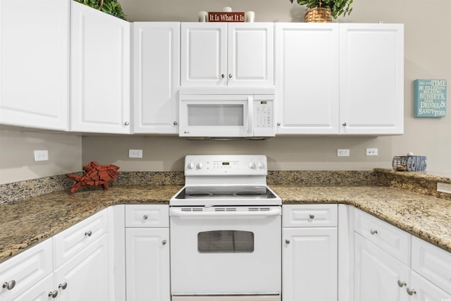 kitchen featuring white cabinetry, dark stone counters, and white appliances