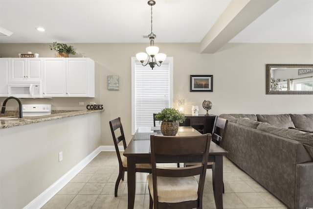 tiled dining space featuring beamed ceiling, a notable chandelier, and sink