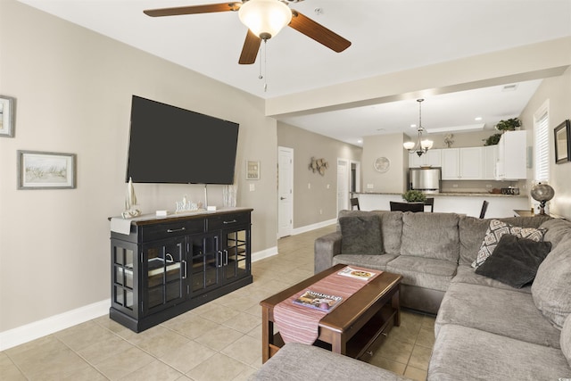 living room featuring ceiling fan with notable chandelier and light tile patterned floors