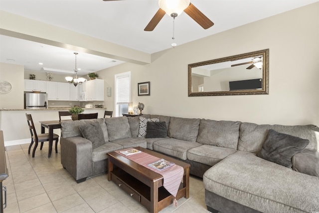 tiled living room featuring ceiling fan with notable chandelier