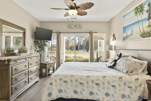 bedroom with ceiling fan, light hardwood / wood-style floors, and access to exterior