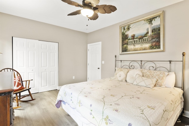 bedroom featuring ceiling fan, light hardwood / wood-style flooring, and a closet