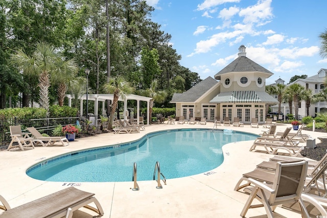 view of pool with a patio area and french doors