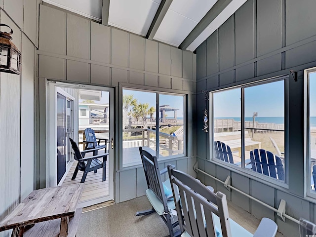 sunroom / solarium with plenty of natural light and a water view