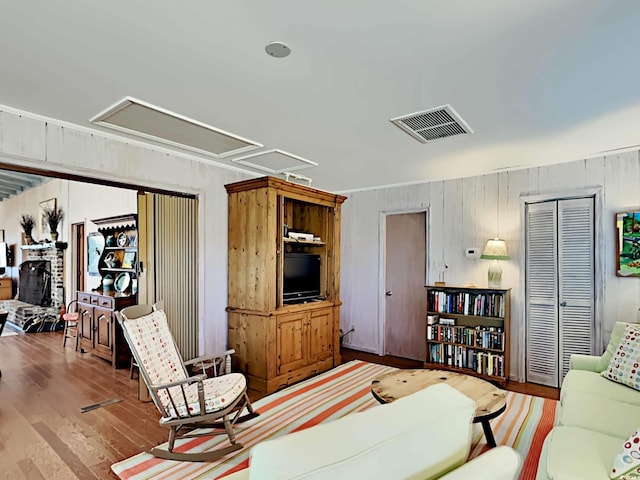 living room with wooden walls and hardwood / wood-style floors