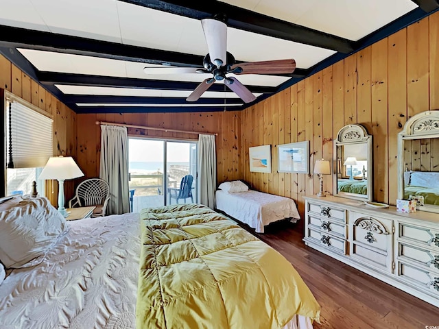 bedroom featuring wood walls, access to outside, lofted ceiling with beams, ceiling fan, and dark hardwood / wood-style flooring