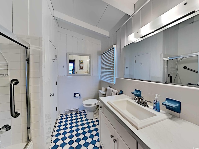 bathroom with vanity, an enclosed shower, and toilet