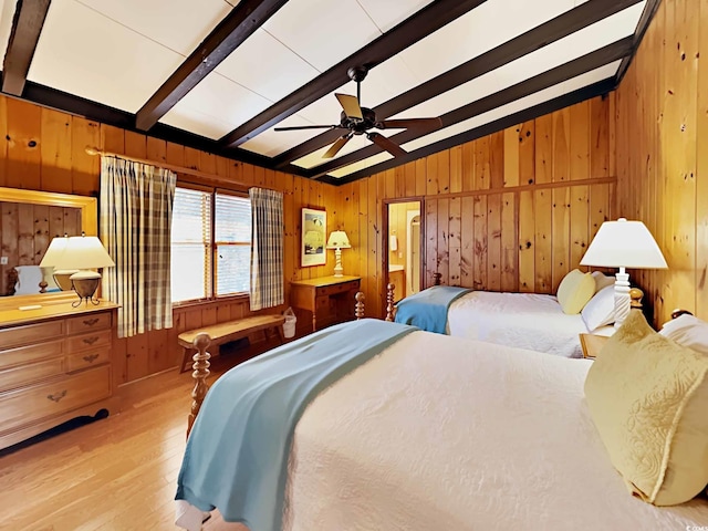 bedroom with vaulted ceiling with beams, ceiling fan, and light wood-type flooring