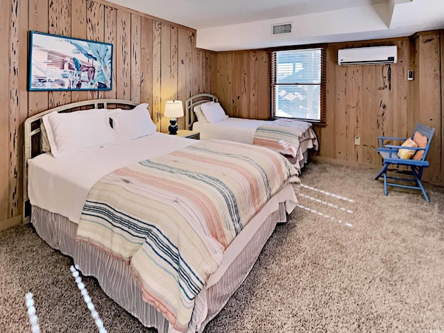 bedroom with carpet floors and a wall unit AC