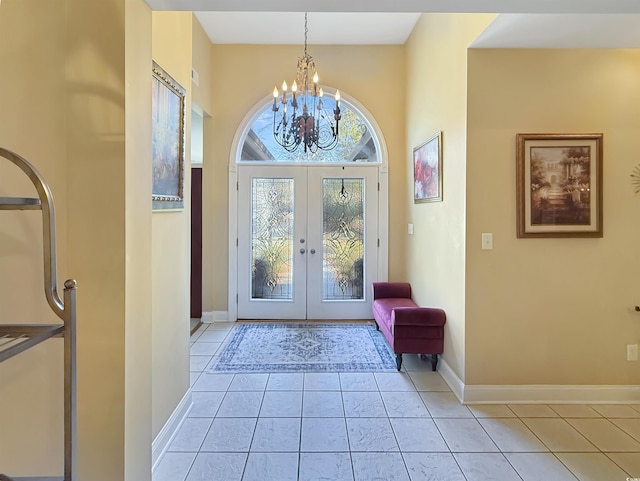 entryway featuring a chandelier, french doors, and light tile patterned flooring