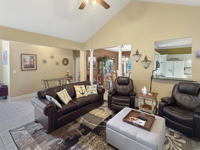 living room featuring light tile patterned floors, ceiling fan with notable chandelier, decorative columns, and high vaulted ceiling