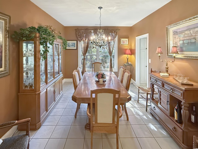 tiled dining space featuring a chandelier