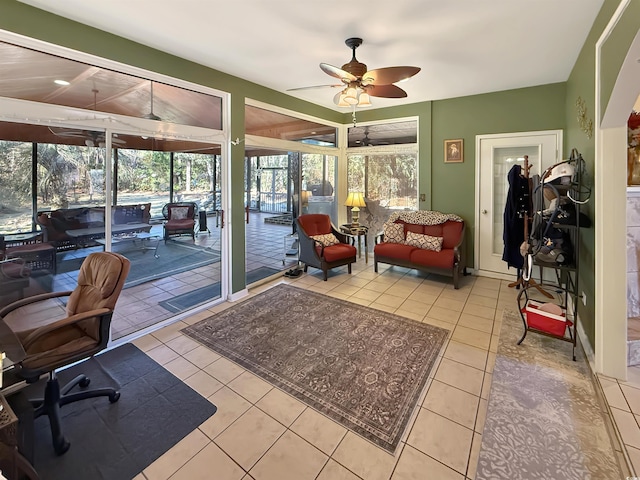 sunroom / solarium featuring ceiling fan