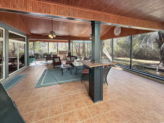 unfurnished sunroom featuring ceiling fan, lofted ceiling, and wood ceiling