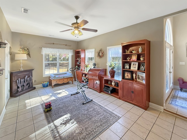 sitting room with light tile patterned floors and ceiling fan