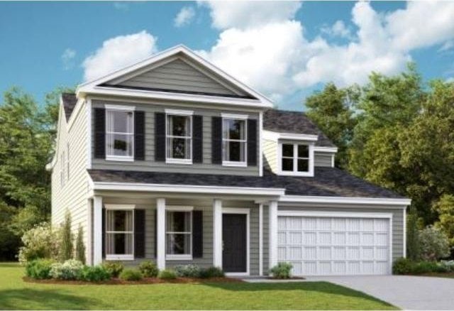 view of front of property with a garage, concrete driveway, and a front lawn