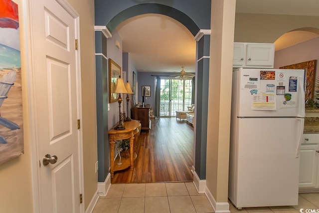 hall featuring light tile patterned floors