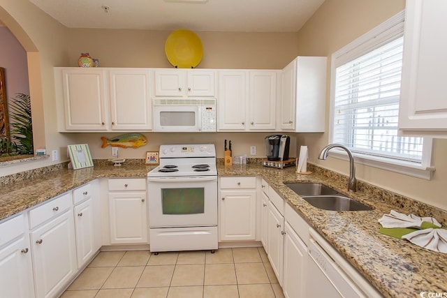 kitchen featuring white cabinetry, sink, light tile patterned flooring, and white appliances