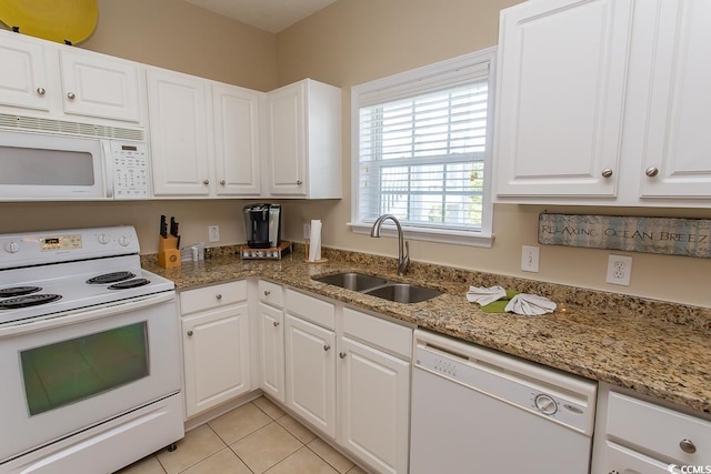 kitchen featuring white cabinetry, sink, stone countertops, and white appliances