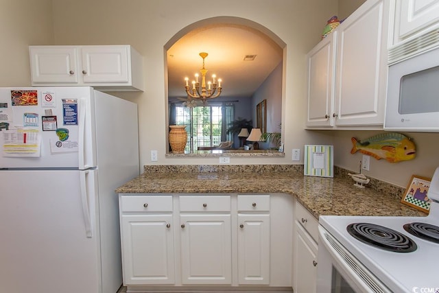 kitchen featuring white cabinetry, decorative light fixtures, white appliances, and an inviting chandelier