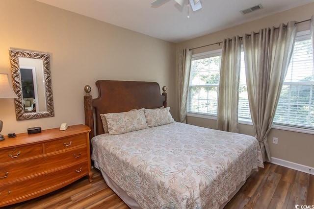 bedroom featuring multiple windows, ceiling fan, and dark wood-type flooring