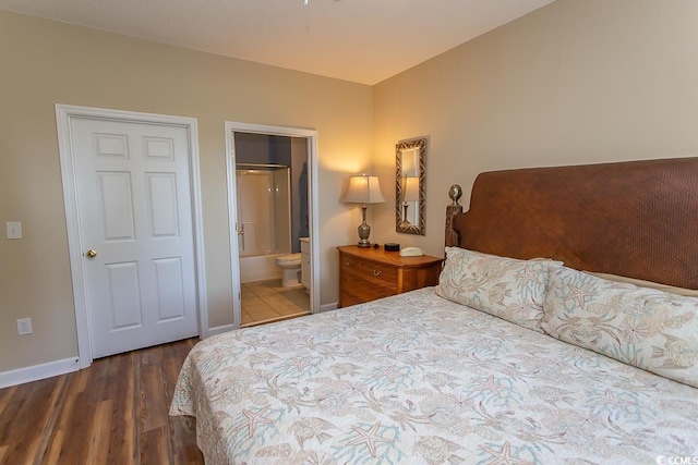 bedroom with hardwood / wood-style flooring and ensuite bathroom