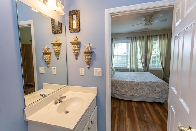 bathroom featuring wood-type flooring, vanity, and ceiling fan